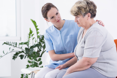 caregiver comforting a senior woman
