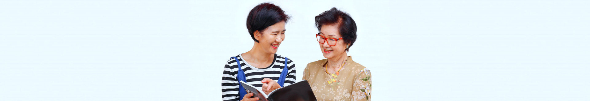 caregiver reading diary to a senior woman
