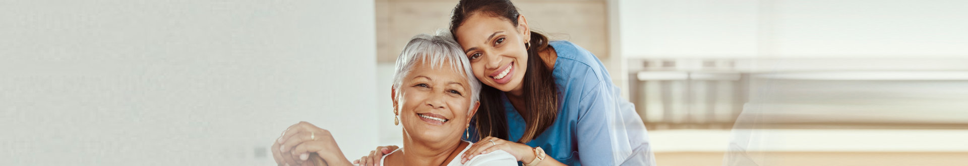 elderly woman and caregiver smiling